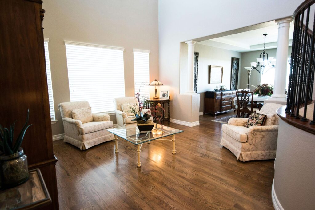 Square Clear Glass-top Center Table Near Gray Padded Armchair